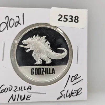 Sale Photo Thumbnail #863: 2021 Niue Godzilla 1 oz silver bullion coin in a protective cardboard flip holder.