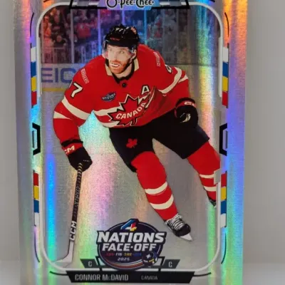 Sale Photo Thumbnail #231: O-Pee-Chee Connor McDavid trading card with a silver foil rainbow finish, featuring the 2025 4 Nations Face-Off logo.