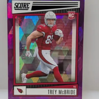 Sale Photo Thumbnail #557: 2022 Score Trey McBride rookie card featuring a purple mosaic parallel, numbered 176/299, in good condition.