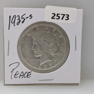 Sale Photo Thumbnail #898: 1935-S Peace silver dollar stored in a protective cardboard coin flip.