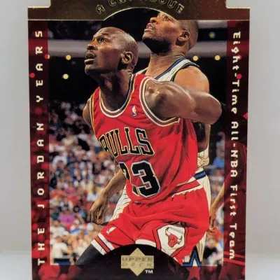 Sale Photo Thumbnail #624: 1998-99 Upper Deck Michael Jordan "A Cut Above" insert trading card (#CA1) featuring a die-cut top edge and gold foil detailing.
