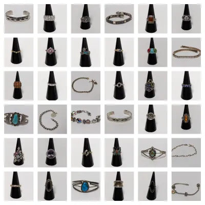 Sale Photo Thumbnail #6: Collection of assorted silver and gemstone jewelry, featuring various rings displayed on black cones, cuff bracelets, and chain bracelets.