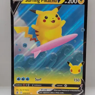 Sale Photo Thumbnail #662: Surfing Pikachu V Pokémon trading card from the 25th Anniversary Celebrations expansion set, numbered 008/025 and released in 2021.