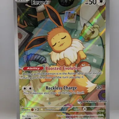 Sale Photo Thumbnail #91: Pokémon TCG Eevee full-art promo card (SVP EN 173) featuring a Pokémon Center stamp and holographic foil finish.