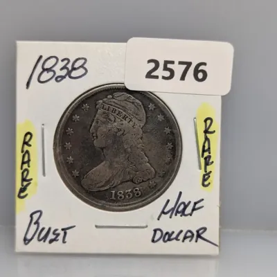 Sale Photo Thumbnail #901: 1838 Capped Bust silver half dollar, housed in a cardboard 2x2 coin holder.