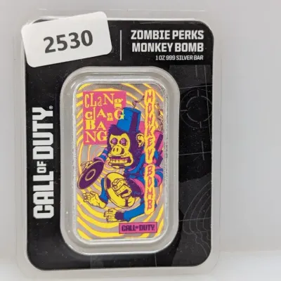 Sale Photo Thumbnail #855: Call of Duty Zombie Perks Monkey Bomb 1 oz .999 silver bar, sealed in original blister card packaging.