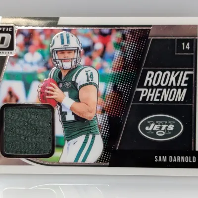 Sale Photo Thumbnail #332: 2018 Donruss Optic Sam Darnold Rookie Phenom jersey swatch relic trading card #14, featuring a green mesh fabric insert.