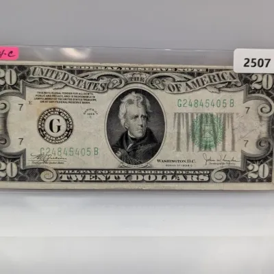 Sale Photo Thumbnail #832: Series of 1934 C $20 Federal Reserve Note featuring Andrew Jackson, enclosed in a protective plastic currency sleeve.
