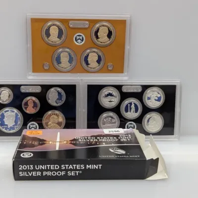 Sale Photo Thumbnail #921: 2013 United States Mint Silver Proof Set, including presidential dollars and national park quarters, complete with original box and protective plastic display cases.