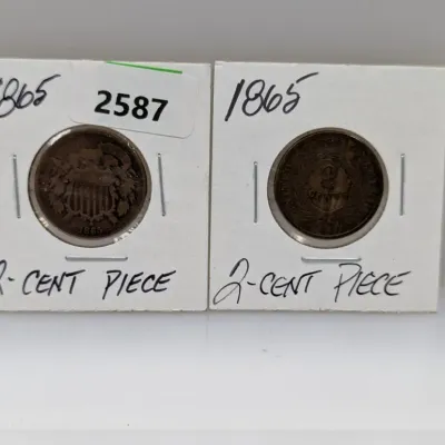 Sale Photo Thumbnail #912: Pair of 1865 US two-cent pieces, each presented in a protective cardboard coin flip with handwritten labels showing the obverse and reverse sides.