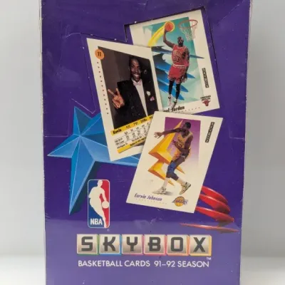 Sale Photo Thumbnail #775: Sealed factory box of 1991-92 SkyBox NBA basketball cards, featuring graphics of Michael Jordan and Earvin Magic Johnson.