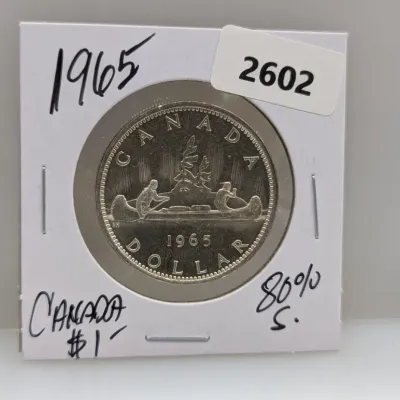 Sale Photo Thumbnail #927: 1965 Canadian silver voyageur dollar coin housed in a protective cardboard flip holder.