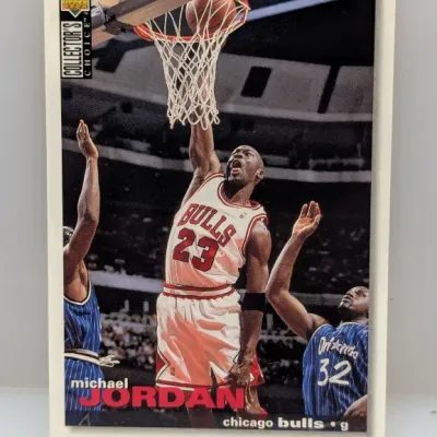 Sale Photo Thumbnail #598: 1995-96 Upper Deck Collector's Choice Michael Jordan #23 basketball card featuring an action shot of Jordan dunking over Shaq.