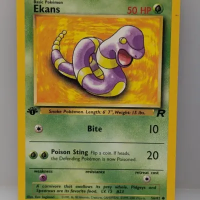 Sale Photo Thumbnail #336: 1st Edition Team Rocket Ekans Pokémon trading card (#56/82), copyright 1999-2000 Wizards of the Coast. Features artwork by Ken Sugimori and appears in good condition.