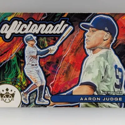 Sale Photo Thumbnail #706: Panini Diamond Kings Aaron Judge 'Aficionado' insert trading card featuring a colorful, artistic background and dual portraits of the New York Yankees outfielder.