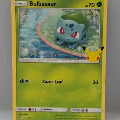 Sale Photo Thumbnail #689: Pokémon 25th Anniversary Celebration Bulbasaur trading card (1/25), illustrated by Mizue, in excellent condition.