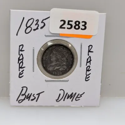 Sale Photo Thumbnail #908: 1835 Capped Bust silver dime, housed in a cardboard cardboard coin flip with handwritten identification.