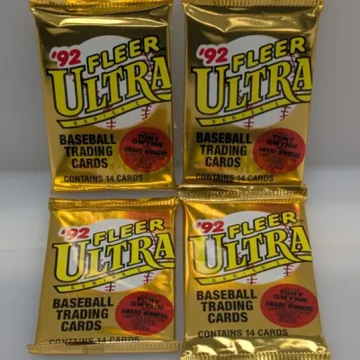 Sale Photo Thumbnail #402: Four unopened wax packs of 1992 Fleer Ultra Series 1 baseball trading cards in metallic gold foil packaging.