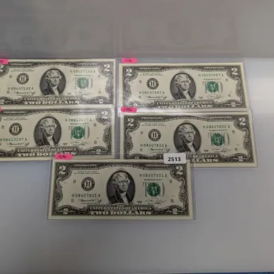 Sale Photo Thumbnail #838: Collection of five 1976 Series $2 Federal Reserve Notes, each housed in protective clear sleeves.
