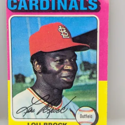 Sale Photo Thumbnail #174: 1973 Topps #320 Lou Brock baseball card featuring the St. Louis Cardinals outfield player. The card exhibits light edge wear and minor corner rounding.