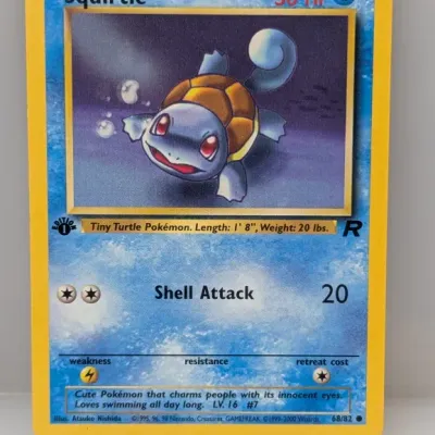 Sale Photo Thumbnail #440: 1st Edition Squirtle Pokemon trading card from the Team Rocket set, numbered 68/82, illustrated by Atsuko Nishida and released in 2000.