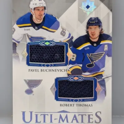 Sale Photo Thumbnail #474: Upper Deck Ultimate Collection Ulti-Mates dual jersey relic trading card featuring Pavel Buchnevich and Robert Thomas of the St. Louis Blues.