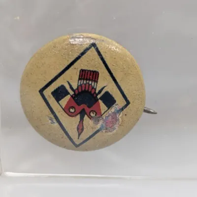 Sale Photo Thumbnail #67: Vintage Camp Fire Girls pinback button featuring the thunderbird symbol, showing visible surface wear and age-related distressing.