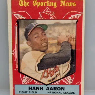 Sale Photo Thumbnail #48: 1959 Topps Hank Aaron All-Star Selection baseball card #561, featuring a red 'The Sporting News' border design.