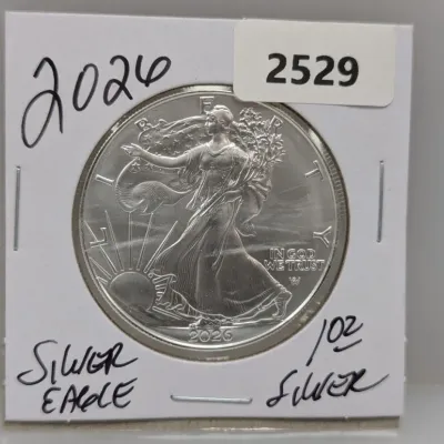 Sale Photo Thumbnail #854: 2026 American Silver Eagle 1 oz fine silver coin, obverse side, housed in a cardboard 2x2 coin holder.
