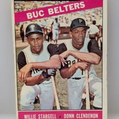 Sale Photo Thumbnail #300: 1966 Topps #215 'Buc Belters' baseball card featuring Willie Stargell and Donn Clendenon of the Pittsburgh Pirates, showing light corner wear.