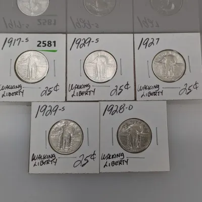 Sale Photo Thumbnail #906: Collection of five Standing Liberty US silver quarter dollars dating from 1917 to 1929, individually packaged in labeled paper cardboard flips.