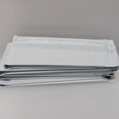 Sale Photo Thumbnail #477: Stack of sealed white plastic foil packets, unopened and in clean condition.