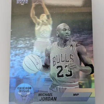 Sale Photo Thumbnail #417: 1992-93 Upper Deck Michael Jordan MVP hologram trading card, featuring the Chicago Bulls star with a metallic reflective finish.