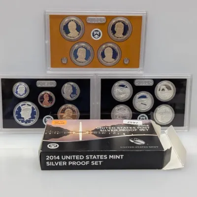 Sale Photo Thumbnail #922: 2014 United States Mint Silver Proof Set, complete with three hard plastic display cases and original packaging.