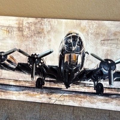 Sale Photo Thumbnail #4: Large panoramic canvas wall art depicting a vintage World War II B-17 bomber airplane on a runway against a textured blueprint background.