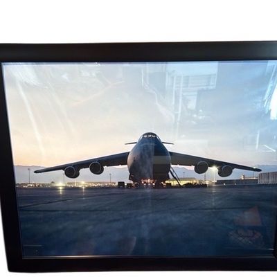 Sale Photo Thumbnail #39: Framed photograph of a military transport aircraft on a tarmac, presented in a simple black frame under glass.