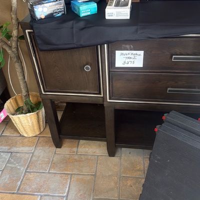 Sale Photo Thumbnail #33: Dark wood multi-purpose table console with drawers and lower shelf, displays electronics and small household goods.