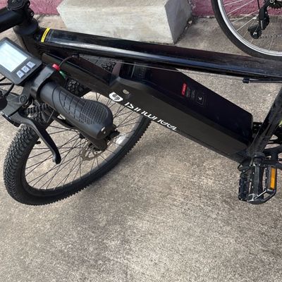 Sale Photo Thumbnail #6: Black Isinwheel electric bicycle featuring a frame-mounted removable battery pack, digital display unit, and disc brakes.