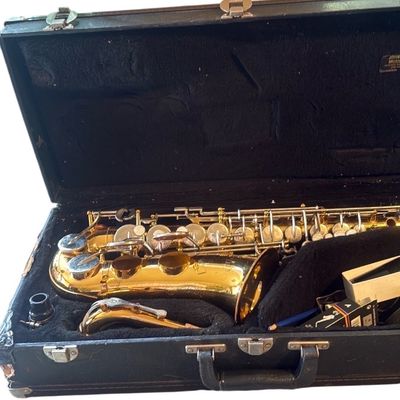 Sale Photo Thumbnail #2: Vintage brass saxophone resting inside a plush-lined hard shell carrying case with accessories.