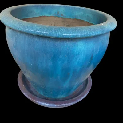 Sale Photo Thumbnail #381: Vibrant glazed ceramic outdoor planter pot in a mottled teal blue finish  featuring a wide rolled rim and matching attached drip tray saucer.  