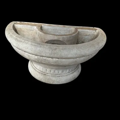 Sale Photo Thumbnail #399: Substantial weathered cast stone fountain/birdbath features two winged cherubs/putti flanking a central pedestal basin set under an arched floral trellis back.  