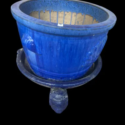 Sale Photo Thumbnail #383: Rich cobalt blue glazed ceramic garden planter featuring embossed scallop shell relief side medallions  resting on a matching separate saucer with tripod feet base.  