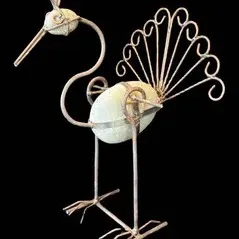 Sale Photo Thumbnail #3: Rustic metal and stone peacock garden sculpture featuring a curved neck, fan-shaped wire tail, and light-colored river rock body accent.