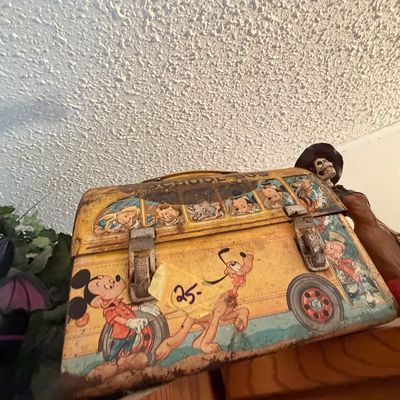 Sale Photo Thumbnail #93: Vintage Disney School Bus tin lunchbox featuring Mickey Mouse, Pluto, and other classic characters, showing light surface rust and wear.