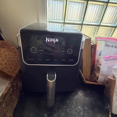 Sale Photo Thumbnail #8: Ninja digital air fryer in a dark grey finish, set on a kitchen countertop.