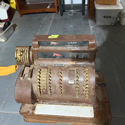 Sale Photo Thumbnail #120: Vintage National Cash Register in a painted brown metal casing with brass keys, side crank, and a wooden base platform.
