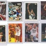 Collection of 12 vintage basketball trading cards, including Michael Jordan and Kevin Garnett, housed in protective top-loader cases.