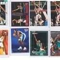 Collection of 1990s and 2000s NBA trading cards displayed in protective plastic sleeves.