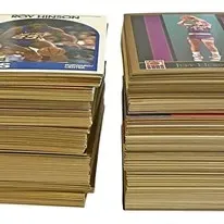 Two tall stacks of vintage NBA basketball trading cards, including 1989-90 NBA Hoops series cards.
