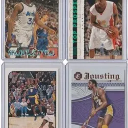 Set of four collectible basketball trading cards in protective top loaders, including Shaquille O'Neal, Kobe Bryant, and Magic Johnson.